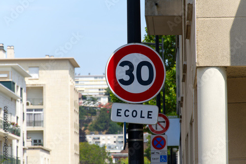Close-up of 30 speed limit sign with school sign at French city of Le Havre on a sunny summer day. Photo taken July 14th, 2026, Le Havre, Normandie, France.