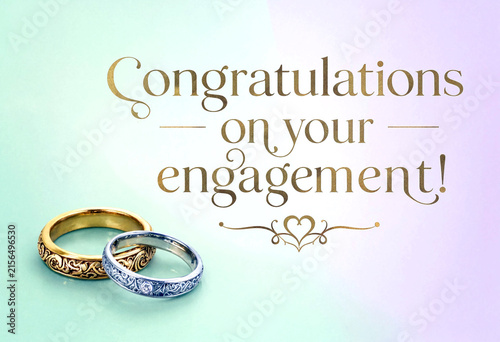 Beautiful golden and silver engagement rings with congratulations message on soft pastel background