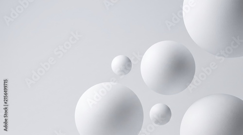 Abstract composition of floating white spheres on a clean gray background