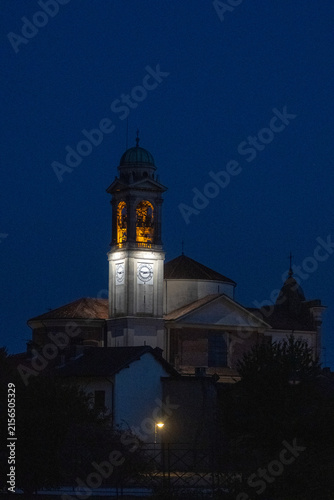 Illuminated Historic Church and Bell Tower at Blue Hour in Italy