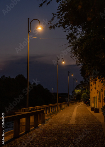 Illuminated Riverside Promenade at Blue Hour in Robecco sul Naviglio, Italy
