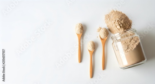 Beige protein powder in glass jar with wooden spoons on transparent background