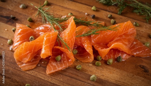 Smoked Salmon Ribbons with Capers and Dill on Wooden Board