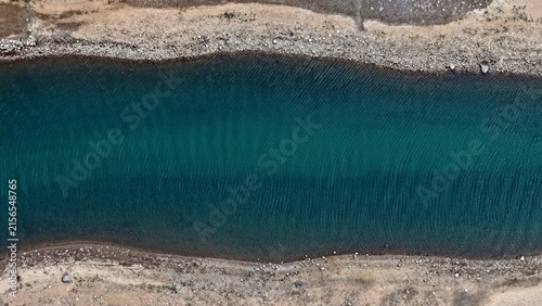 Aerial view of the turquoise waters of Twin Lakes, surrounded by rocky, gravelly shorelines in Twin Lakes, Colorado, United States.