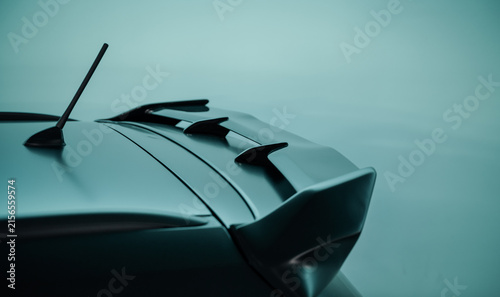 Foto Rear spoiler on black car against bright teal background