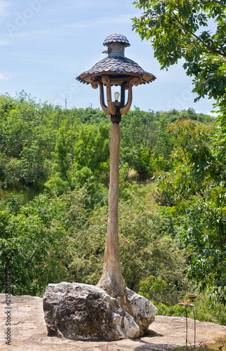 wooden lamppost against the backdrop of a forest