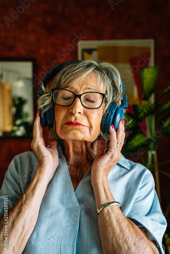 Senior woman relaxing with closed eyes listening to music