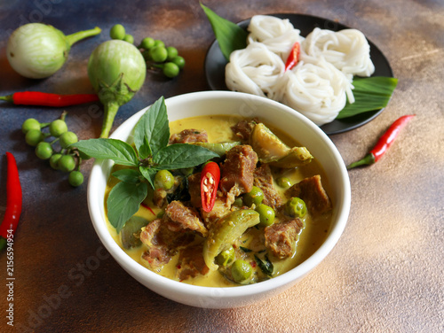Beef green curry with eggplant, chili and basil serve with rice noodle. Authentic Thai food.