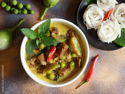 Beef green curry with eggplant, chili and basil serve with rice noodle. Authentic Thai food.
