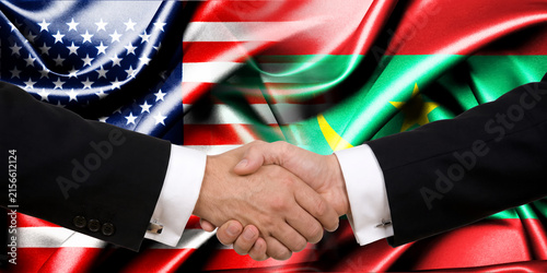 Handshake between the United States and Mauritania, international friendship, background with flags. Flags.