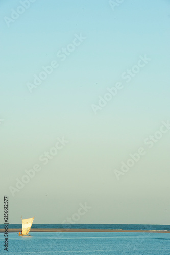 Madagascar, Morondava, Fisherman boat with large white sails at sea