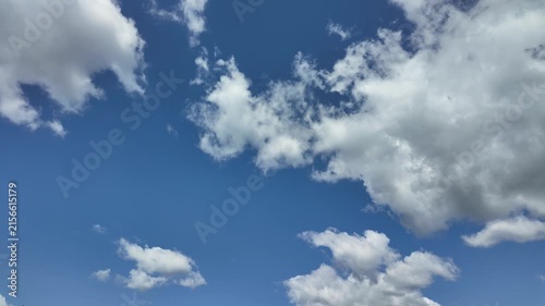 Timelapse of white clouds flying in the blue sky.