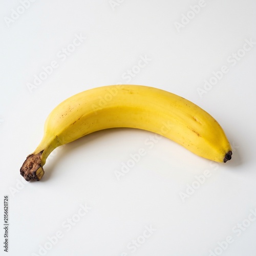 Single ripe yellow banana isolated on a clean white background for food photography.