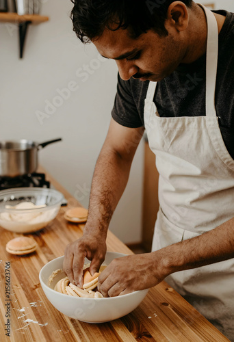 Man in apron preparing maca...
