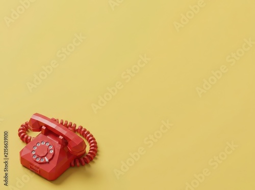 Vintage red rotary telephone on yellow background.
