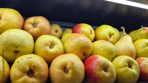Freshly Picked Yellow and Red Pears Arranged on a Shelf for Sale at a Local Grocery Store or Farmers Market