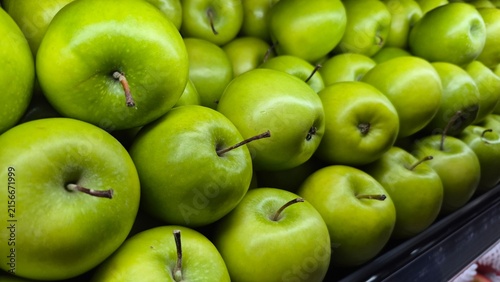Vibrant Green Apples Piled High in a Grocery Store Produce Section for Healthy Eating and Fresh Food Concepts