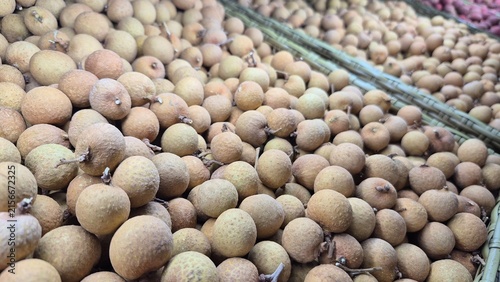 Freshly Harvested Organic Longan Fruit Displayed for Sale at a Vibrant Asian Market Stall for Food Retailers