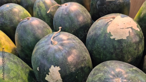 Freshly Harvested Dark Green Watermelons Displayed at Market Stall for Healthy Eating and Summer Refreshment