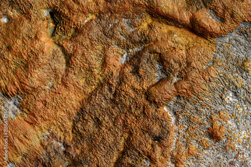 Earthy rust and gray rock background with coarse surface detail
