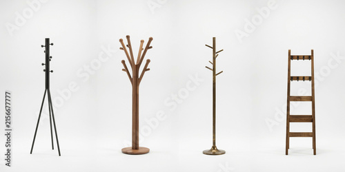 Four various freestanding coat stands arranged on a white background