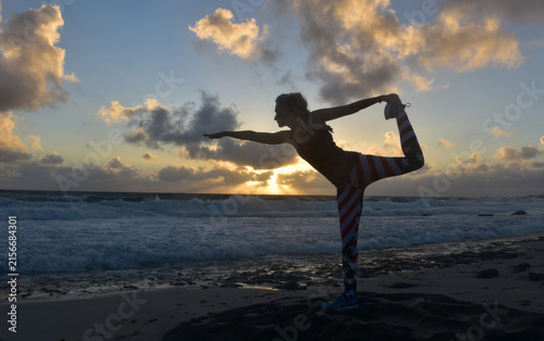 Silhouetted Female Yogi in Natarajasana Dancer Pose at Dawn
