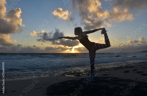 Woman Gracefully Performing Dancer Yoga Pose at Sunrise in Aruba
