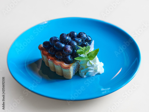 Delicious blueberry tart with a fresh, healthy food background isolated in white background