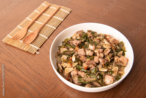 Fotografie Cumi sambal ijo, or salted squid stir-fried with chopped green chilies and garlic, is a popular home-cooked seafood dish in Indonesia
