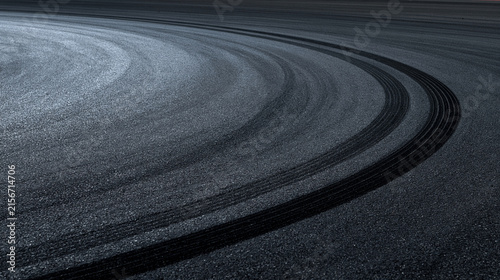 Elegent photo of Black tire skid marks on asphalt race track curve. Conceptual image for automotive performance and dangerous high speed driving.