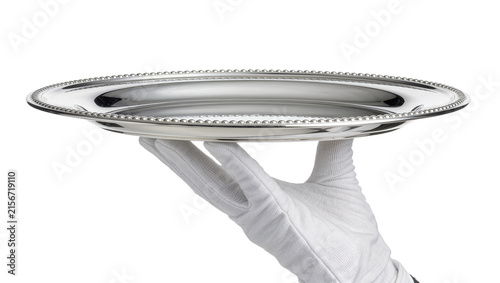 Fotografie White gloved hand holding a polished silver beaded platter, isolated on transpar