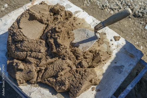 Bild auf Leinwand Mortar/cement  mixed on a board with a trowel showing