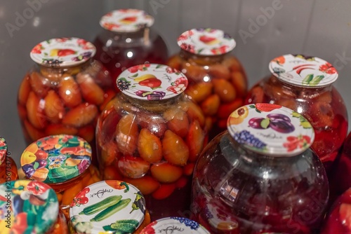 Top view of large glass jars with homemade sweet plum compote
