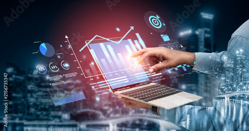Принти на полотні Businessman Interacting with Digital Analytics and Data Visualization on Laptop in Urban Night Setting with Charts and Graphs Haptic