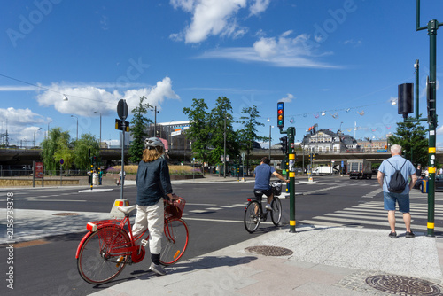 Sticker People cycling and waiting at Stockholm city street crossing