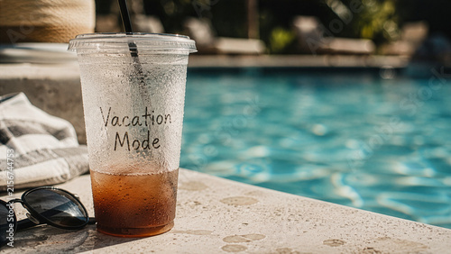 Vacation Mode Drink by Swimming Pool with Sunglasses on Sunny Summer Day