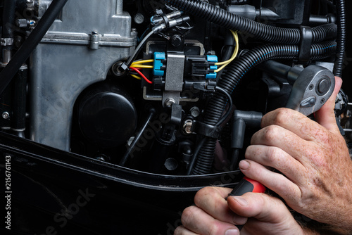 Hands Using Ratchet Wrench During Outboard Engine Service