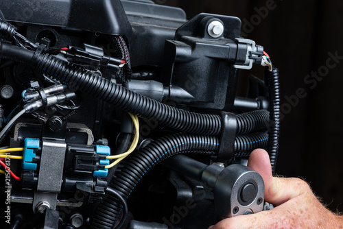 Mechanic Using Ratchet During Outboard Engine Maintenance