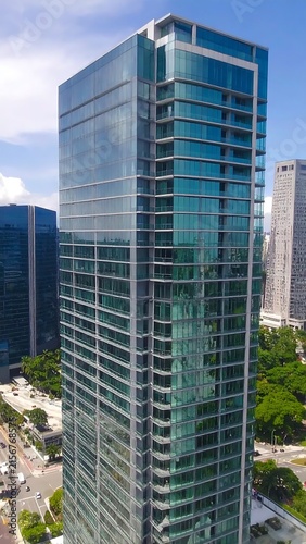 Modern glass skyscraper in urban business district.