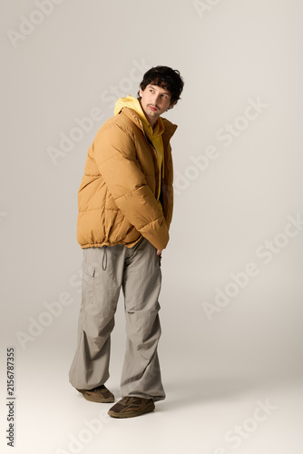 Canvastavla Stylish man in warm attire showcases cozy fashion in a bright studio setting