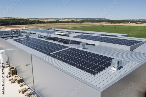 Industrial building roof displaying solar panels for renewable energy