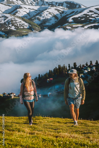 Couple friends man and woman hiking in Georgia family travel vacations explore Caucasus mountains together  romantic tour summer adventure healthy lifestyle outdoors - people enjoying Gomis Mta view