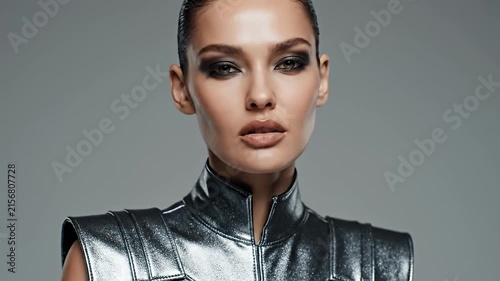 Woman wearing black futuristic textured metallic collar.