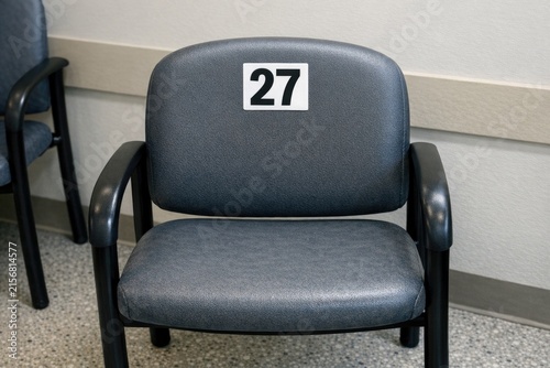 A simple black chair with a single number displayed prominently