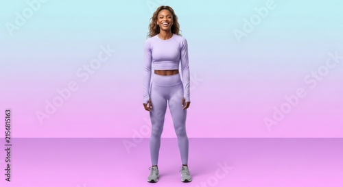 Smiling Woman in Lavender Activewear Standing in Gradient Studio