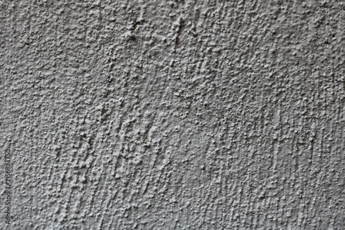 Quadro su tela A neutral grey rough plaster or stucco wall surface.