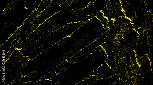 Abstract charcoal texture with gold highlights painted on dark surface for artistic design backgrounds.