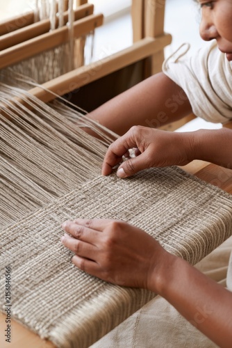 Traditional weaving process in artisan workshop for handmade textile design