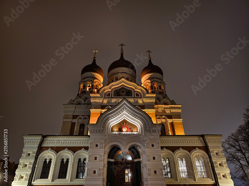 Photography Symmetrical low angle night view of illuminated facade and onion domes of Alexander Nevsky Cathedral in Tallinn, Estonia