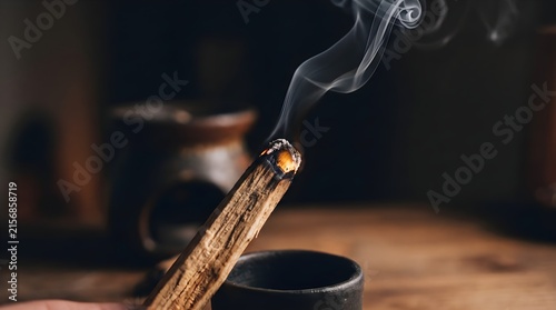 Burning palo santo stick with aromatic smoke. Spiritual cleansing ritual with holy wood. Zen meditation and aromatherapy concept.